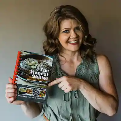Katie Yakle, owner of The Honest Skillet, holding her cookbook
